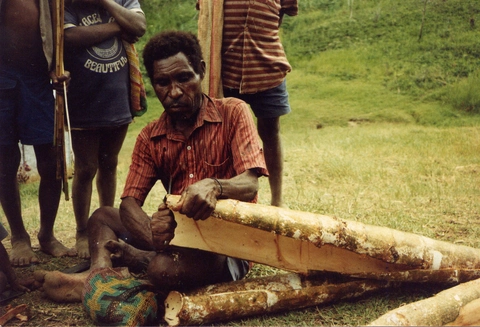 a man preparing bark for a cape